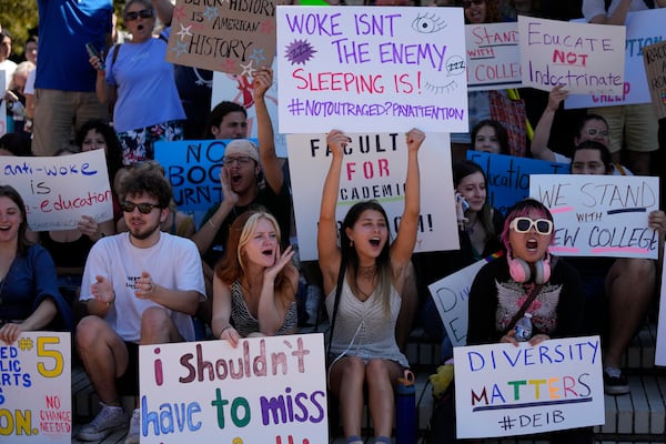 FILE - New College of Florida students and supporters protest ahead of a meeting by the college's board of trustees, Feb. 28, 2023, in Sarasota, Fla. The conservative-dominated board of trustees of Florida's public honors college was meeting to take up a measure making wholesale changes in the school's diversity, equity and inclusion programs and offices. (AP Photo/Rebecca Blackwell, File)