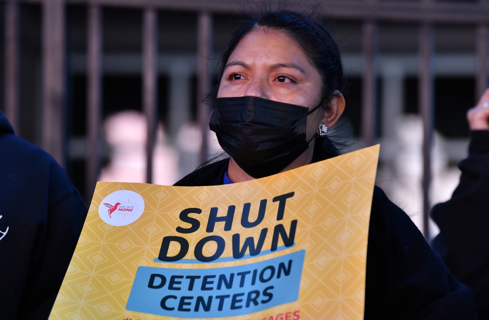 A protester holds a sign during a rally to demand Biden to shut down detention centers, free immigrant detainees and stop deportations outside ICE Atlanta Field Office on Thursday, September 23, 2021. (Hyosub Shin / Hyosub.Shin@ajc.com)