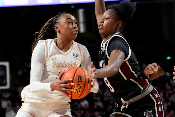 Vanderbilt guard Mikayla Blakes, left, goes to the basket past South Carolina forward Joyce Edwards (8) during the first half of an NCAA college basketball game Sunday, Feb. 23, 2025, in Nashville, Tenn. (AP Photo/George Walker IV)