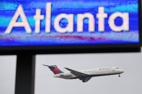 A Delta jet lands at Hartsfield-Jackson International Airport.  JOHN SPINK / JSPINK@AJC.COM