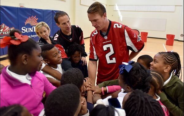 Falcons quarterback Matt Ryan holds a huddle with third-graders at M. Agnes Jones Elementary as the kids prepare to run drills at the Atlanta school. (Brant Sanderlin/www.ajc.com)