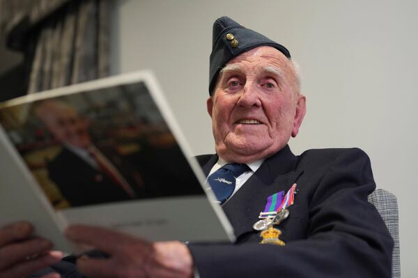 Michael Woods, 100-year-old World War II veteran, poses for a photograph during an interview in Dunstable, Bedfordshire, England, Tuesday, Nov. 5, 2024. (AP Photo/Kin Cheung)