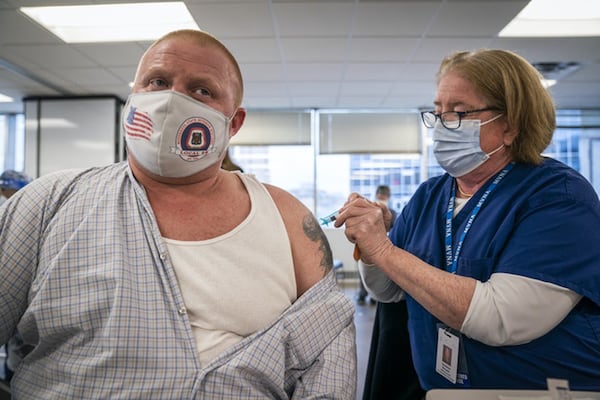 Christine Runyon administered the Moderna COVID-19 vaccine to Michael Christy at United Labor Center in Minneapolis recently. (LEILA NAVIDI/Minneapolis Star Tribune/TNS)