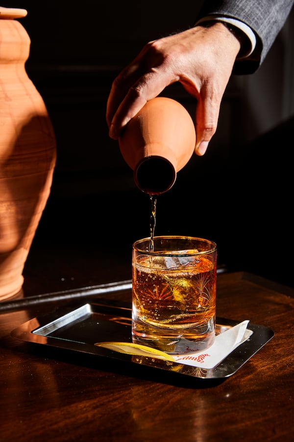 Among the cocktails at Brasserie Margot is an aged mezcal negroni poured from a clay pot. (Courtesy of Kathryn McCrary)