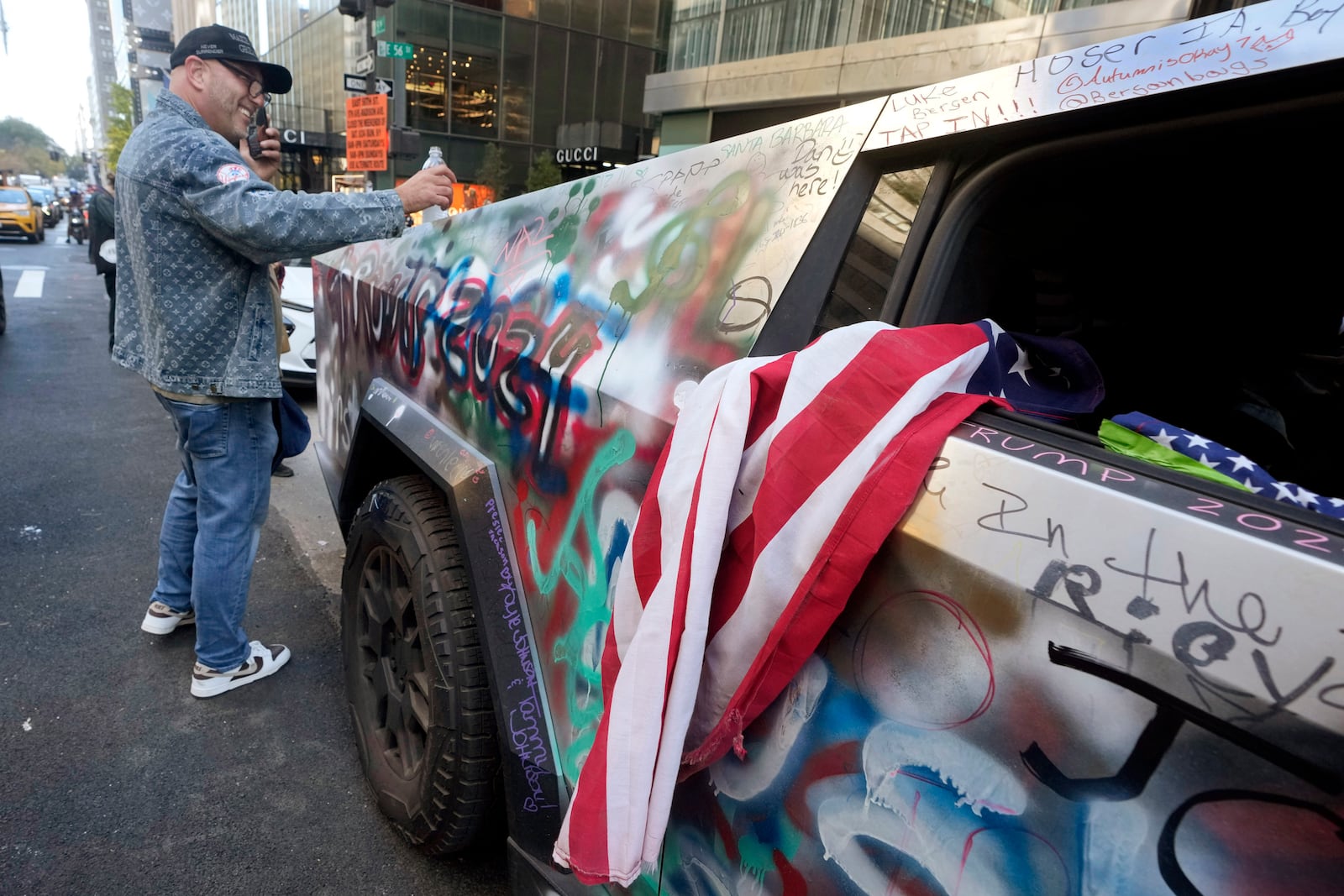 A Trump 2024 decorated Tesla Cybertruck is parked adjacent to Trump Tower, on New York's Fifth Avenue, Tuesday, Nov. 5, 2024. (AP Photo/Richard Drew)