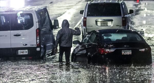 January 4, 2023 ATLANTA: Near Turner Field, motorists became stranded after trying to drive through standing water along Pollard Boulevard on Wednesday morning, January 4, 2023. Several routes were canceled or delayed due to flooding. The rain that moved in Tuesday evening brought with it flash flooding, severe thunderstorms and tornado watches across the state on Wednesday. Rolling severe thunderstorm warnings cropped up sporadically throughout metro Atlanta before daybreak as the system moved eastward, causing damaging wind gusts up to 73 mph and toppling trees as it rolled through. Several roads and portions of interstates had standing water as of 8:30 a.m. Just on I-285, at least five areas had flooding that caused all or partial lane closures, according to the Georgia Department of Transportation. All westbound lanes at Ga. 400 were closed, as were the westbound lanes to the I-85 exit. Thursday’s forecast will be mostly sunny with a high of 62 degrees according to Channel 2 Action News meteorologist Brian Monahan. (John Spink / John.Spink@ajc.com)

