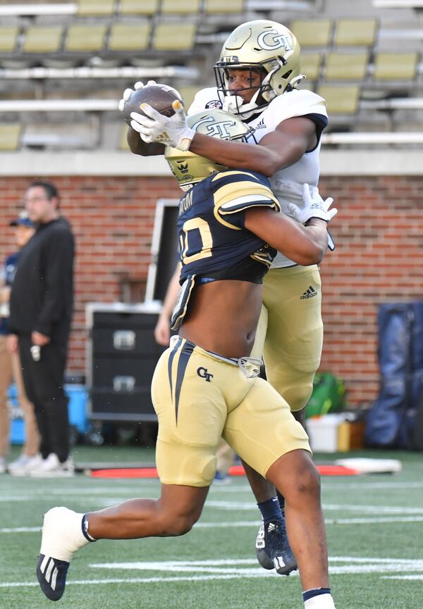 March 17, 2022 Atlanta - Georgia Tech's wide receiver Peje' Harris (18) makes a catch over Georgia Tech's linebacker Trenilyas Tatum (40) during the 2022 Spring Game at Georgia Tech's Bobby Dodd Stadium in Atlanta on Thursday, March 17, 2022. (Hyosub Shin / Hyosub.Shin@ajc.com)