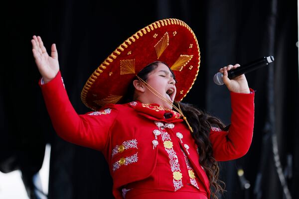 Twelve-year-old singer Solange Trujillo, know as “La Flor de Jalisco,” performs mariachi songs on the main stage during the Cinco de Mayo festival at Plaza Fiesta on May 7. Miguel Martinez /miguel.martinezjimenez@ajc.com