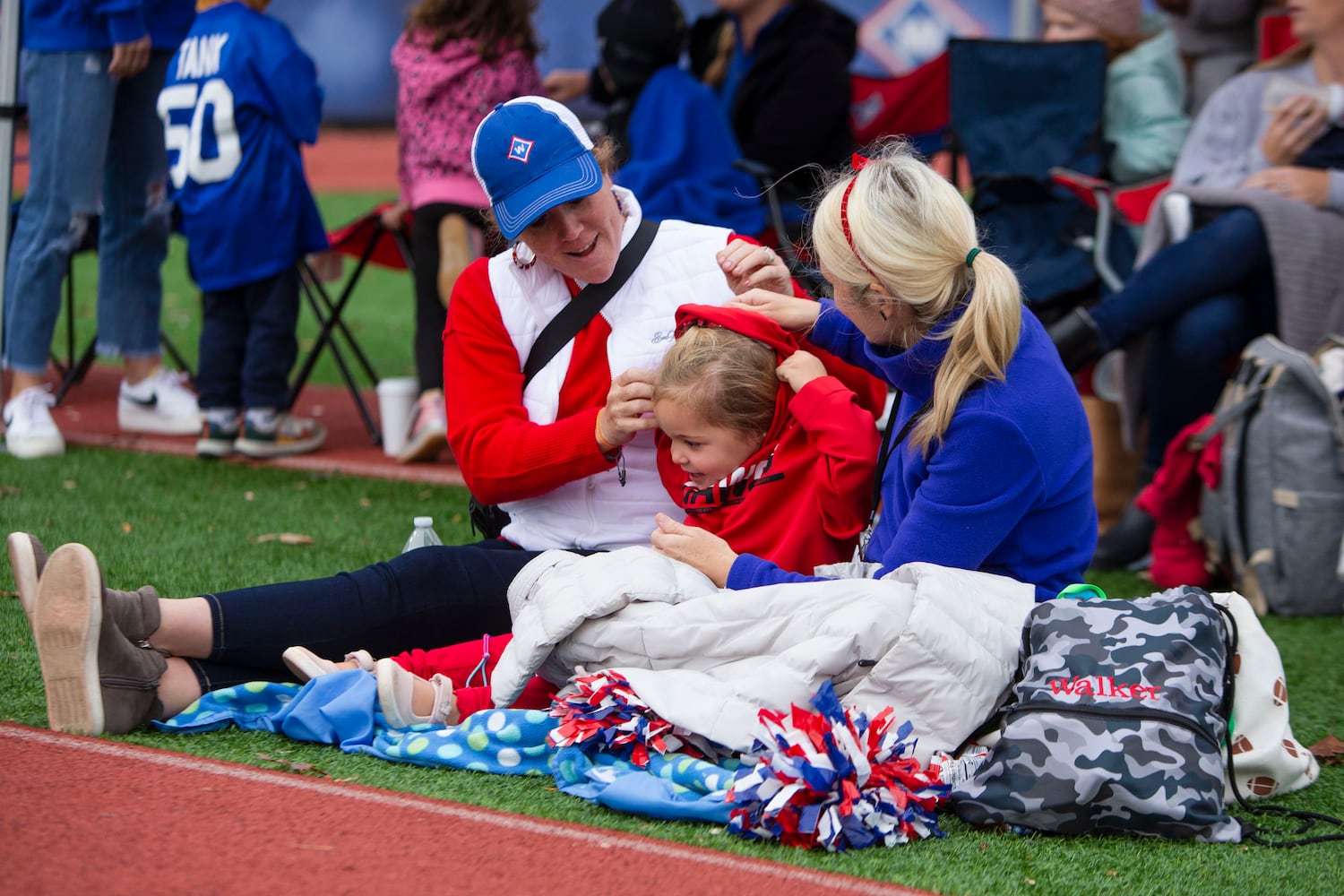 (Left to right) Katie Chillion, Emerson Dial and Katie Dial get bundled up on the sidelines. CHRISTINA MATACOTTA FOR THE ATLANTA JOURNAL-CONSTITUTION.