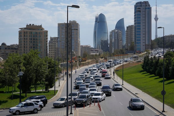 Vehicles travel down a street in Baku, Azerbaijan, Monday, Sept. 16, 2024. (AP Photo/Sergei Grits)