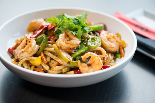  CO Spicy Udon with shrimp, spicy black pepper sauce, snow peas, bell peppers, white onion, scallions, carrots, celery, and jalapenos.