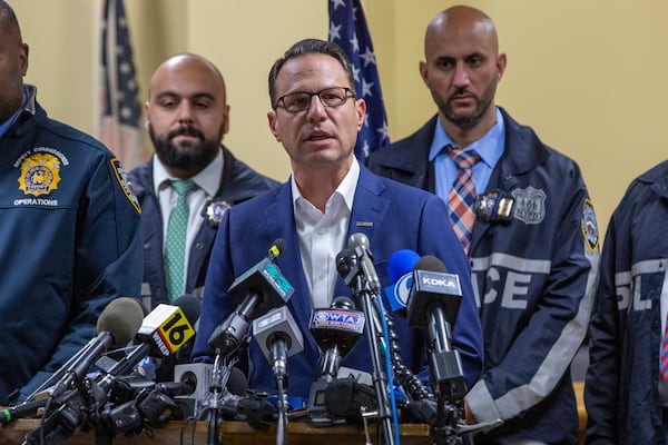 Gov. Josh Shapiro, center, speaks during a press conference regarding the arrest of suspect Luigi Mangione, Monday, Dec. 9, 2024, in Hollidaysburg, Pa., in the fatal shooting of UnitedHealthcare CEO Brian Thompson. (AP Photo/Ted Shaffrey)