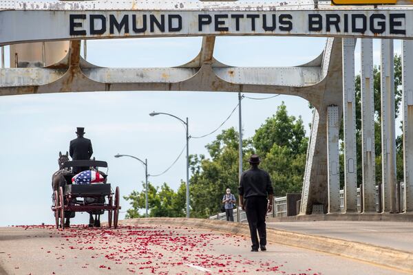 The body of Rep. John Lewis is taken across the Edmund Pettus Bridge in Selma, Ala., on Sunday.