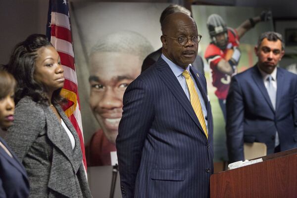 Monteria Robinson (left) listens as Fulton County District Attorney Paul Howard announces the filing of a lawsuit against the United States Department of Justice in the death of her son Jamarion Robinson during a press conference on December 28th, 2018. (Photo by Phil Skinner)