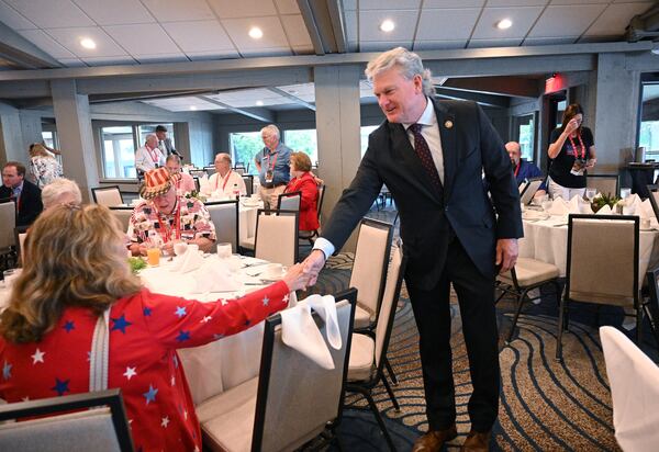 U.S. Rep. Mike Collins, R-Jackson, shakes hands with Alice O'Lenick (left),  an alternate delegate from Gwinnett County attending the Republican National Convention.