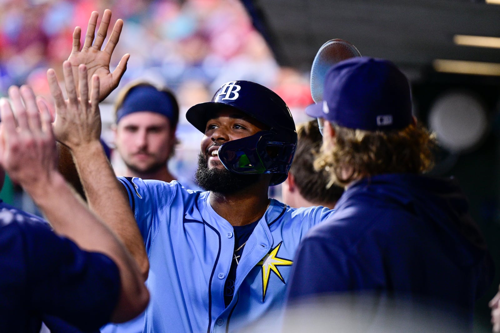 Tampa Bay Rays' Junior Caminero high fives teammates in the dugout after scoring during the second inning of a baseball game against the Philadelphia Phillies, Tuesday, Sept. 10, 2024, in Philadelphia. (AP Photo/Derik Hamilton)