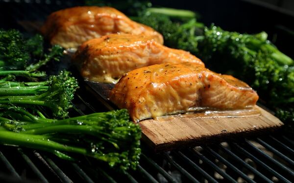 Cedar Plank Dijon Salmon with Broccolini on the grill on August 9, 2017. (Eric Seals/Detroit Free Press/TNS)