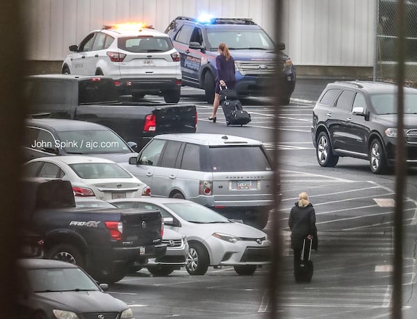 Delta security and Atlanta police monitor the Delta employee parking lot Monday morning after an employee was fatally shot Sunday night.