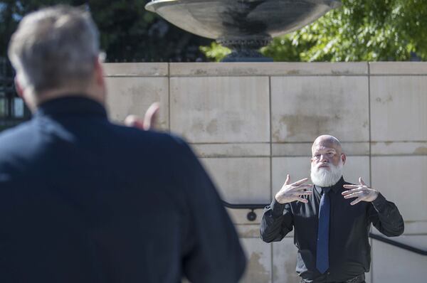 David Cowan (right), an American Sign Language deaf interpreter with All Hands On, interprets remarks made by Gov. Brian Kemp by watching Aaron Shoemaker, executive director of All Hands On, during a press conference at Liberty Plaza in Atlanta on April 20, 2020. Shoemaker, who can hear, interprets Kemp’s words and signs them to Cowan, who then interprets the gestures into better digestible phrases for people whose first language is ASL. 