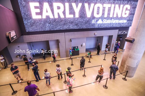 October 12, 2020 Atlanta: Big Marquee billboard fanfare greeter voters on Monday, Oct. 12, 2020 at State Farm Arena in downtown Atlanta. Eager Georgia voters swarmed to polling places Monday morning, waiting in lines created by high turnout and technical problems at the start of three weeks of early voting before Election Day. A glitch with voter check-in computers held up voters at Georgia’s largest early voting site at State Farm Arena. Lines stopped after voters received an “invalid card” error when inserting green voter access cards into touchscreens. Poll workers had to reboot the arena’s 60 voter check-in tablets and re-import voter information, said Fulton Elections Director Richard Barron. “We apologize to all the voters,” Barron said. (John Spink / John.Spink@ajc.com).