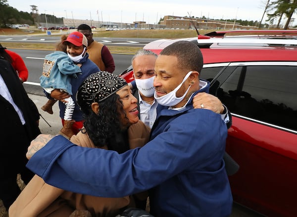 Devonia Inman is embraced by his mother, Dinah Ray, and stepfather, David Ray, after being released from custody at Augusta State Medical Prison after serving 23 years of a life sentence. The Legislature did not act this year on his request for compensation in the wrongful conviction. (Curtis Compton/Atlanta Journal-Constitution/TNS)