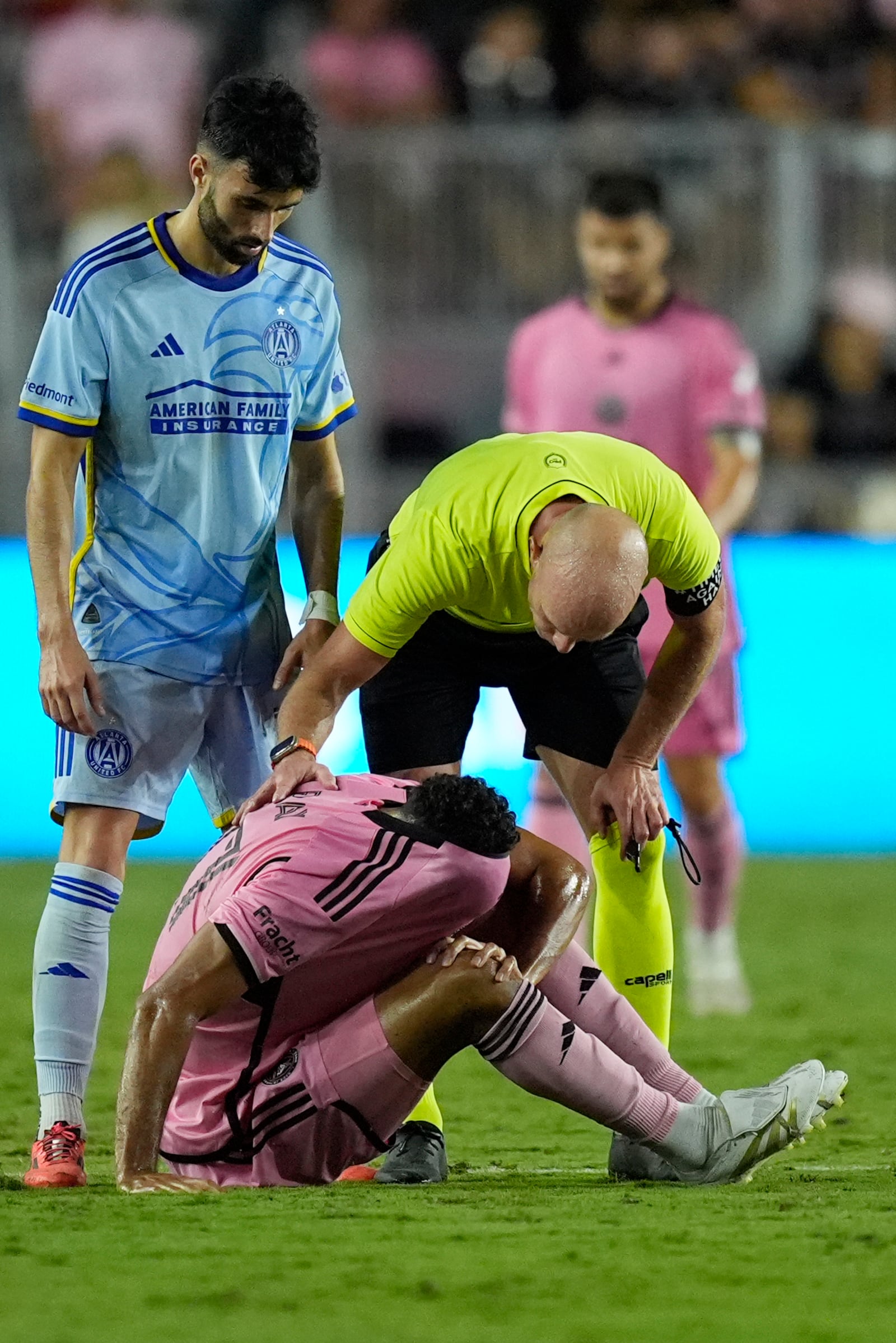 Inter Miami defender Ian Fray (17) is assisted on the field after he was injured during the second half of their MLS playoff opening round soccer match against Atlanta United, Friday, Oct. 25, 2024, in Fort Lauderdale, Fla. (AP Photo/Rebecca Blackwell)