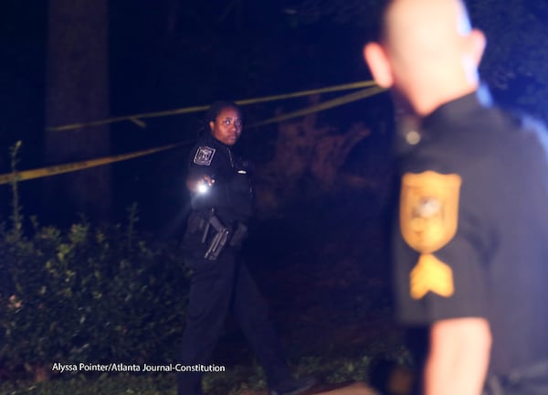 DeKalb police officers work the scene at a condominium community.  ALYSSA POINTER / ALYSSA.POINTER@AJC.COM