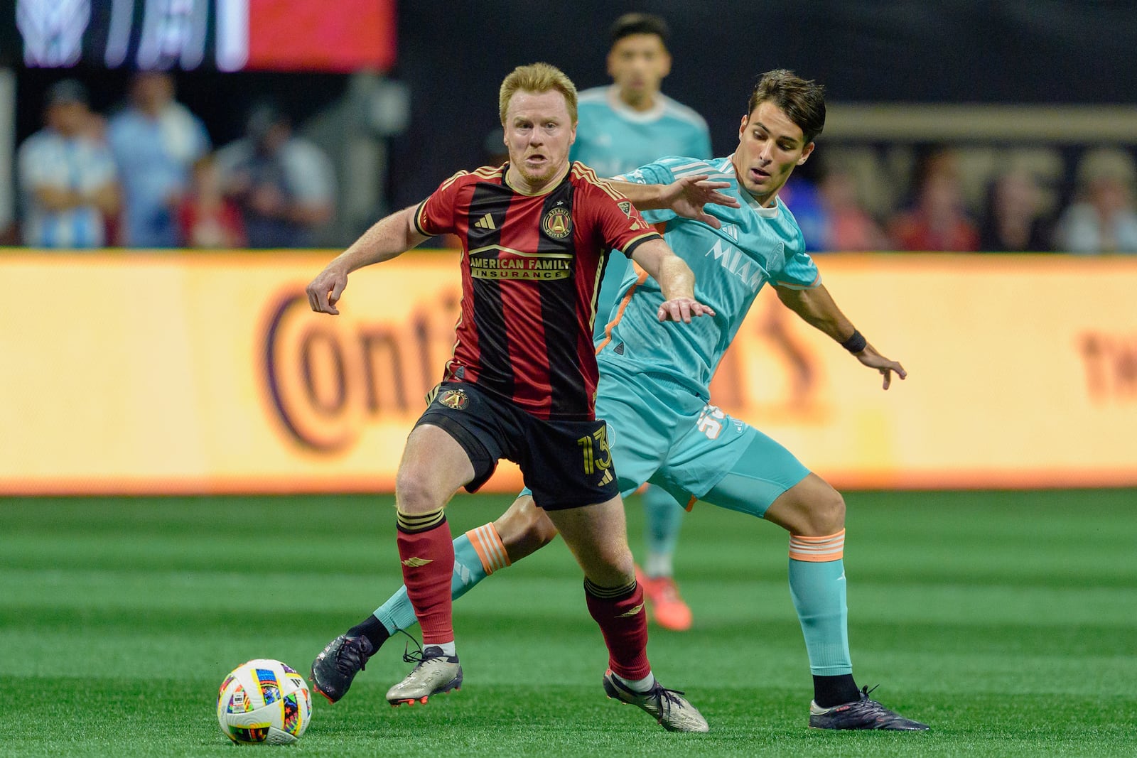 Atlanta United midfielder Dax McCarty (13) maintains control of the ball during the first half of an MLS soccer match against Inter Miami, Saturday, Nov. 2, 2024, in Atlanta. (AP Photo/Jason Allen)