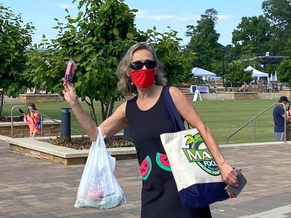 King of Pops carts pop up at many local farmers markets. This shopper is headed off with a pop purchased at the Sandy Springs Farmers Market.
Courtesy of Sandy Springs Farmers Market