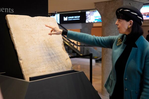 Sharon Liberman Mintz, Sotheby's Judaica Specialist, Books & Manuscripts, discusses the oldest complete tablet of the Ten Commandments, weighing 115-pounds and approximately 1,500 years old, that is displayed at Sotheby's, in New York, Monday, Dec. 9, 2024, where it is to be offered for auction in a single lot sale, Dec, 18, 2024. (AP Photo/Richard Drew)