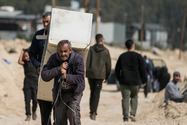 Residents of the West Bank urban refugee camp of Nur Shams evacuate their homes and carry their belongings as the Israeli military continues its operation in the area on Wednesday, March 5, 2025. (AP Photo/Majdi Mohammed)