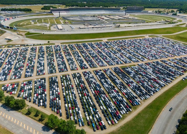 An aerial photo shows thousands of rental cars from Enterprise parked in the lots surrounding the Atlanta Motor Speedway in Hampton on May 12, 2020. The coronavirus has caused rental car demand to plummet so Enterprise sought a place to store its cars. (Hyosub Shin / Hyosub.Shin@ajc.com)