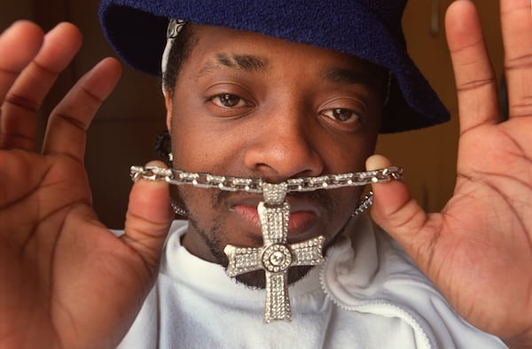 Jermaine Dupri (cq) shows off a diamond-studded cross and necklace in an AJC archival photo. (RICH ADDICKS/AJC staff)