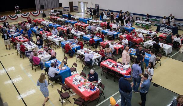 People fill the picnic tables during the 6th Congressional District BBQ Roundup in Roswell. STEVE SCHAEFER / SPECIAL TO THE AJC