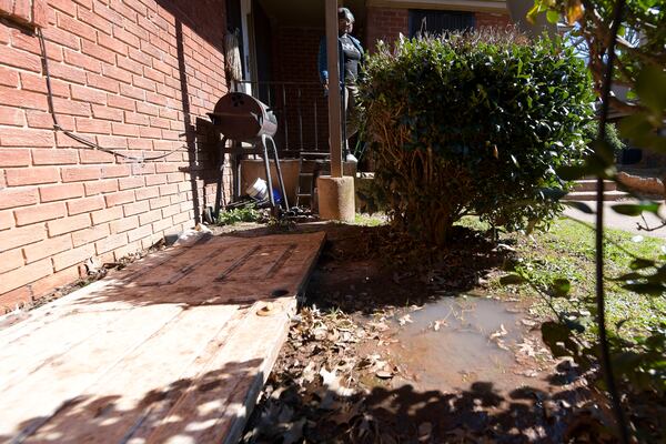 A puddle of raw sewage (bottom right of picture) stands in front of Lolita Evans’ apartment at the Forest Cove apartment complex Tuesday, Feb. 1, 2022. (Daniel Varnado/For the Atlanta Journal-Constitution)