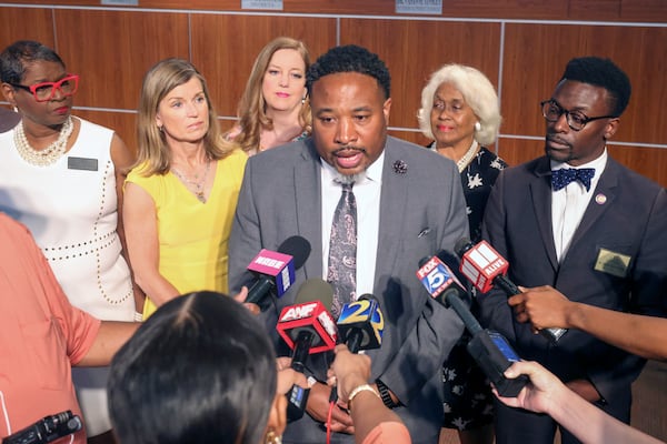 Devon Horton talks with members of the media after the DeKalb County Board of Education hired Horton for the superintendent position at the DeKalb County Administrative Center, Wednesday, April 19, 2023, in Stone Mountain, Ga. Shown behind Horton are five of the six board members who voted yes for Horton. (Jason Getz / Jason.Getz@ajc.com)