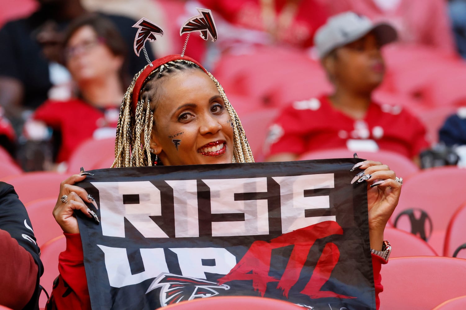 A Falcons fan cheers for her team Sunday at Mercedes-Benz Stadium. (Miguel Martinez / miguel.martinezjimenez@ajc.com)