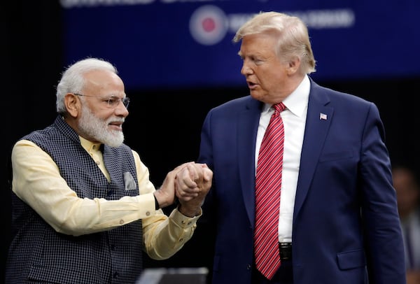 FILE - Prime Minister Narendra Modi and President Donald Trump, right, shake hands after introductions during the "Howdi Modi" event, Sept. 22, 2019, at NRG Stadium in Houston. (AP Photo/Michael Wyke, File)