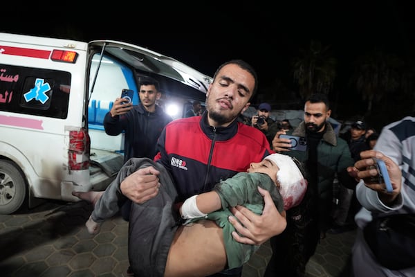 A Palestinian child injured in an Israeli strike on a building arrives at Al-Aqsa Hospital in Deir al-Balah, Gaza Strip, Thursday, Dec. 12, 2024. (AP Photo/Abdel Kareem Hana)