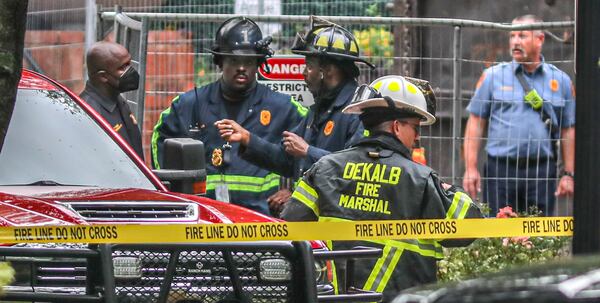 DeKalb County fire investigators returned to the complex Tuesday as utility officials purged gas lines. (John Spink / John.Spink@ajc.com)