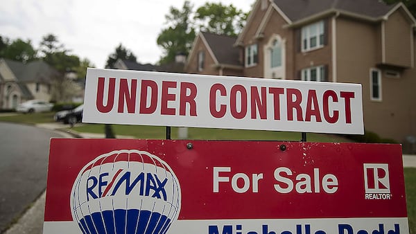 A home for sale sign is displayed in the yard of a home in Powder Springs, Tuesday, April 7, 2020. AJC File 