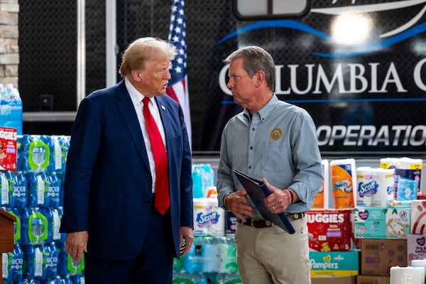 Former President Donald Trump (left), then the Republican nominee for president, and Gov. Brian Kemp speak after a news conference about recovery from Hurricane Helene in Evans, Ga., on Friday, Oct. 4, 2024. Trump visited Georgia in the aftermath of Hurricane Helene, which devastated much of the South. (Doug Mills/New York Times 2024)
                      