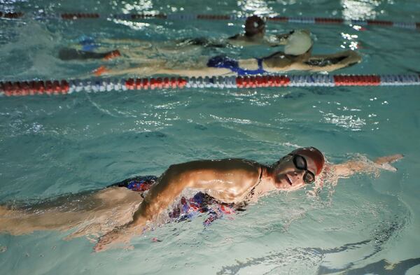 Vicki Bunke trains at about 5 a.m at a pool in Marietta to prepare for the Swim Across America event. She was keeping a promise to her daughter Grace, who died in March. BOB ANDRES / BANDRES@AJC.COM