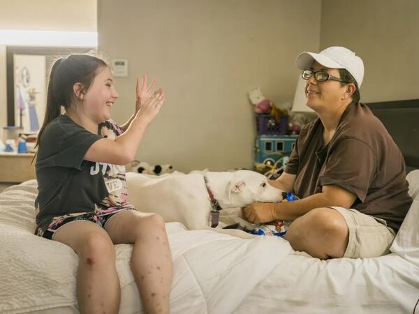 Heaven talking to her mother Melissa Bullard on the bed at the Days Inn in Brunswick, Georgia, Friday, Sept. 6, 2024. (Photo Courtesy of Justin Taylor/The Current GA)