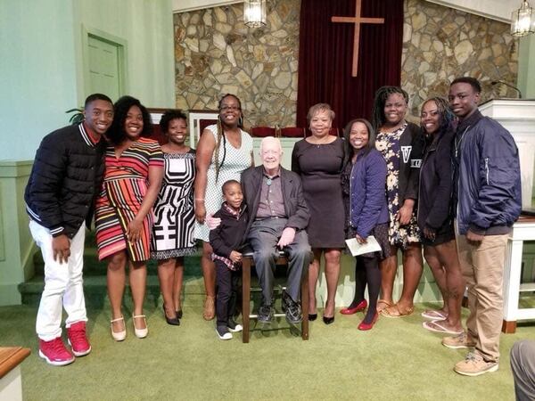 Eddrica Buckner, (blue jacket with the red shoes) and her family with President Carter during one of his Sunday School classes in 2018. 