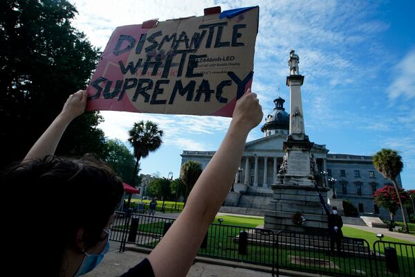 A demonstrator protests in front of a Civil War statue in Columbia, South Carolina.