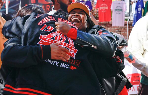 Clark Atlanta University alumna Hali Smith hugs her Delta Sigma Theta Sorority Inc. sorors during homecoming weekend on Friday, October 14, 2022. (Natrice Miller/natrice.miller@ajc.com)  