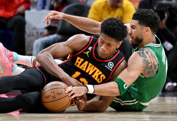 Atlanta Hawks' forward De'Andre Hunter (12) fights for a loose ball with Boston Celtics' forward Jayson Tatum (right) during the second half in Game 4 of the first round of the Eastern Conference playoffs at State Farm Arena, Sunday, April 23, 2023, in Atlanta. Boston Celtics won 129-121 over Atlanta Hawks. (Hyosub Shin / Hyosub.Shin@ajc.com)