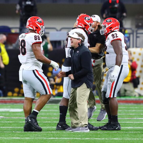 1/10/22 - Indianapolis -Georgia Bulldogs head coach Kirby Smart with Georgia Bulldogs defensive lineman Jalen Carter (88) after his blocked field goal in the third quarter at the 2022 College Football Playoff National Championship  between the Georgia Bulldogs and the Alabama Crimson Tide at Lucas Oil Stadium in Indianapolis on Monday, January 10, 2022.   Curtis Compton / Curtis.Compton@ajc.com 