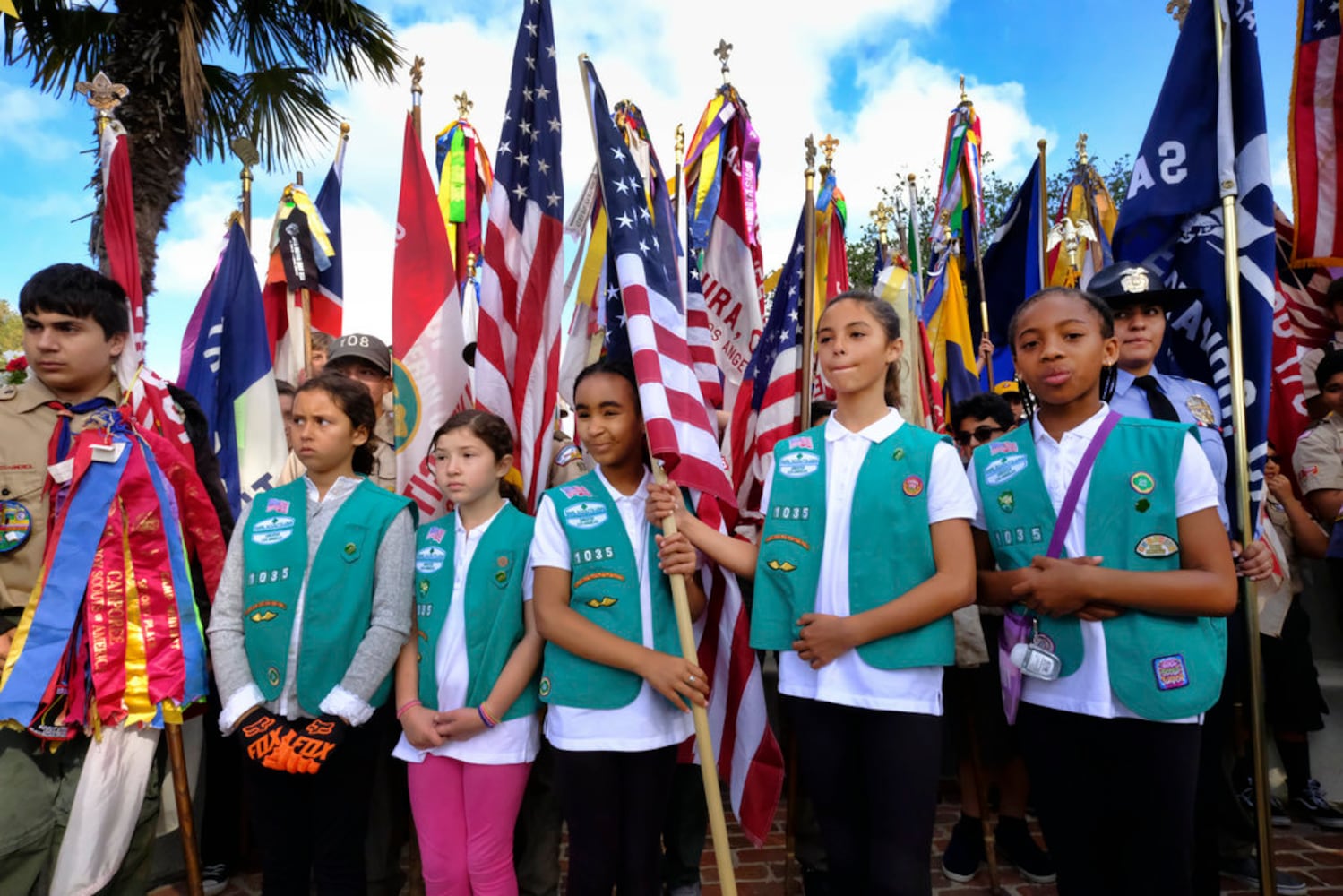 scouts place flags at veteran graves to honor memorial day